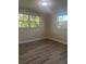 Cozy bedroom features modern floors and natural light from dual windows at 2020 45Th Street Ct E # A, Bradenton, FL 34208