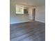Open-concept living space features durable wood-look flooring and a breakfast bar at 2020 45Th Street Ct E # A, Bradenton, FL 34208