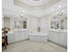 Luxurious primary bathroom features dual vanities, a large soaking tub, and ample natural light at 2161 Gulf Of Mexico Dr # 3, Longboat Key, FL 34228