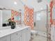 Bathroom featuring a glass shower, statement wall decor, marble countertops and tile floor at 2161 Gulf Of Mexico Dr # 3, Longboat Key, FL 34228
