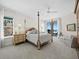 Bright and airy bedroom features a four-poster bed and a stunning ocean view at 2161 Gulf Of Mexico Dr # 3, Longboat Key, FL 34228