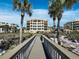 Exterior view of building with palm trees and walkway at 2161 Gulf Of Mexico Dr # 3, Longboat Key, FL 34228