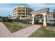 Exterior view of a stylish condo complex near the beach, with a gated entrance and manicured lawn at 2161 Gulf Of Mexico Dr # 3, Longboat Key, FL 34228