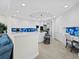 Spacious kitchen featuring white cabinetry, an island with seating, and a dedicated workstation, creating a functional and stylish hub at 2161 Gulf Of Mexico Dr # 3, Longboat Key, FL 34228