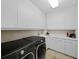 Well-equipped laundry room with modern washer/dryer, ample cabinet space, and countertop at 2161 Gulf Of Mexico Dr # 3, Longboat Key, FL 34228