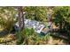 An elevated view of the home showing mature trees, a light-colored roof, and lush landscaping at 2478 Prospect St, Sarasota, FL 34239