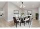 Elegant dining room with a modern glass table, stylish chairs, unique lighting fixture, and sleek wood floors at 25147 Alcazar Dr, Punta Gorda, FL 33955