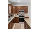 Functional kitchen with stainless steel appliances, granite counters, and wood cabinetry at 255 Annapolis Ln, Rotonda West, FL 33947