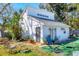 Exterior view of a charming white home with a yard and garden area at 2564 Wood St, Sarasota, FL 34237