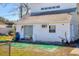 Backyard view of white house featuring a sliding door, window, and patio area at 2564 Wood St, Sarasota, FL 34237