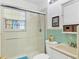 Bright bathroom with a glass-enclosed shower, tiled walls, and modern fixtures at 2564 Wood St, Sarasota, FL 34237
