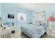 Serene bedroom with soft blue walls, a comfortable bed, and floral-themed decor at 2564 Wood St, Sarasota, FL 34237