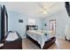 Relaxing bedroom features light blue walls, ceiling fan and natural light from windows and glass paneled door at 2564 Wood St, Sarasota, FL 34237