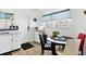 Bright kitchen area with white cabinets, eat in dining and functional layout for easy meal preparation at 2564 Wood St, Sarasota, FL 34237