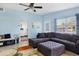 Bright living room with blue walls and a sectional couch, seamlessly connected to the kitchen at 2564 Wood St, Sarasota, FL 34237