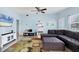 Luminous living room features blue walls, ample seating and an open flow into the kitchen for easy living at 2564 Wood St, Sarasota, FL 34237
