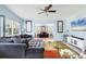 Comfortable living room featuring a plush sectional, bright walls, and an open layout leading to a sunroom at 2564 Wood St, Sarasota, FL 34237