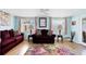 Charming living room with light blue walls, hardwood floors, and stylish furniture with a colorful rug at 2564 Wood St, Sarasota, FL 34237