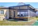 Enclosed patio with hot tub, seating, and screened enclosure, ideal for outdoor enjoyment at 2564 Wood St, Sarasota, FL 34237