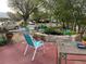 Relax on the patio with outdoor furniture, a tranquil pond, and charming flamingo decor at 2901 Sandpointe Dr, Bradenton, FL 34205