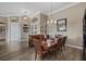 Inviting dining room with wood floors, elegant lighting, and ample space for entertaining at 2927 Bravura Lake Dr, Sarasota, FL 34240