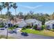 Elevated view of single story home with palm trees, lush lawn and landscaping, and a two car garage at 3333 Yonge Ave # 13, Sarasota, FL 34235