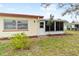 The backyard shows a sunroom door that opens onto a well-maintained lawn, and mature landscaping at 3533 Tree Line Ct # 13, Sarasota, FL 34231