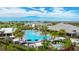 Aerial view of a community pool, clubhouse, and green landscaping surrounded by luxurious homes at 3639 Santa Caterina Blvd, Lakewood Ranch, FL 34211