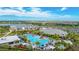 Aerial view of a community pool, clubhouse, and recreation center with lush landscaping and beautiful scenery at 3639 Santa Caterina Blvd, Lakewood Ranch, FL 34211