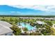 Aerial view of a community pool and surrounding green lawns, golf course, and new home construction at 3639 Santa Caterina Blvd, Lakewood Ranch, FL 34211
