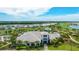 Stunning aerial view of a luxury home with a manicured lawn, lush landscaping, and a beautiful green golf course at 3639 Santa Caterina Blvd, Lakewood Ranch, FL 34211