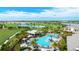 Aerial view of a community pool and golf course with beautiful landscaping and a view of green surroundings at 3639 Santa Caterina Blvd, Lakewood Ranch, FL 34211