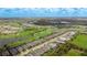 Aerial view of home and community showing lush green golf course, mature trees, and glistening ponds at 3639 Santa Caterina Blvd, Lakewood Ranch, FL 34211