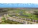 Aerial view showcasing the home's location within a community near a golf course and lake at 3639 Santa Caterina Blvd, Lakewood Ranch, FL 34211