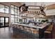 Modern bar area with a large screen TV, ample seating, and a well-stocked counter at 3639 Santa Caterina Blvd, Lakewood Ranch, FL 34211