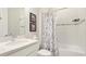 Well-lit bathroom with marble-patterned shower curtain and a modern vanity with a white countertop at 3639 Santa Caterina Blvd, Lakewood Ranch, FL 34211