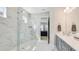 Bright bathroom with a glass shower enclosure, marble tile, and sleek vanity at 3639 Santa Caterina Blvd, Lakewood Ranch, FL 34211