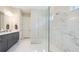 Elegant bathroom with a glass-enclosed shower, marble tile, and double vanity at 3639 Santa Caterina Blvd, Lakewood Ranch, FL 34211