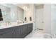 Modern bathroom with double sinks, a large mirror, and access to the shower area at 3639 Santa Caterina Blvd, Lakewood Ranch, FL 34211