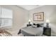 Cozy bedroom with neutral-colored walls, a comfortable-looking bed, and framed artwork on the walls at 3639 Santa Caterina Blvd, Lakewood Ranch, FL 34211