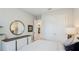 Bedroom featuring a round decorative mirror, closet with double doors, and a comfortable-looking bed at 3639 Santa Caterina Blvd, Lakewood Ranch, FL 34211