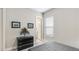 Serene bedroom with a dark-colored dresser, natural light streaming through the window, and simple decor at 3639 Santa Caterina Blvd, Lakewood Ranch, FL 34211