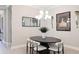 Modern dining room featuring a black oval table, white chairs, and stylish decor at 3639 Santa Caterina Blvd, Lakewood Ranch, FL 34211