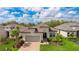 Attractive one-story home features a tile roof, neutral color scheme, verdant landscaping, and an attached garage at 3639 Santa Caterina Blvd, Lakewood Ranch, FL 34211