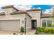 Close up of a beautiful single-story home's entrance, featuring a tile roof, manicured landscaping, and a secure front door at 3639 Santa Caterina Blvd, Lakewood Ranch, FL 34211