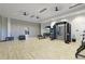 Home gym with extensive exercise equipment, weights, bright lighting, and neutral decor at 3639 Santa Caterina Blvd, Lakewood Ranch, FL 34211
