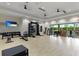 Bright home gym with extensive exercise equipment, weights, and large sliding glass doors to the outside at 3639 Santa Caterina Blvd, Lakewood Ranch, FL 34211
