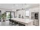 Bright kitchen with a large marble island, stainless steel appliances, and modern lighting at 3639 Santa Caterina Blvd, Lakewood Ranch, FL 34211