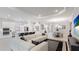 A spacious living area seamlessly connects to a modern, light-filled kitchen and includes a dining area at 3639 Santa Caterina Blvd, Lakewood Ranch, FL 34211