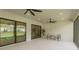 Spacious outdoor patio with ceiling fans, sliding glass doors, and a view of the backyard at 3639 Santa Caterina Blvd, Lakewood Ranch, FL 34211